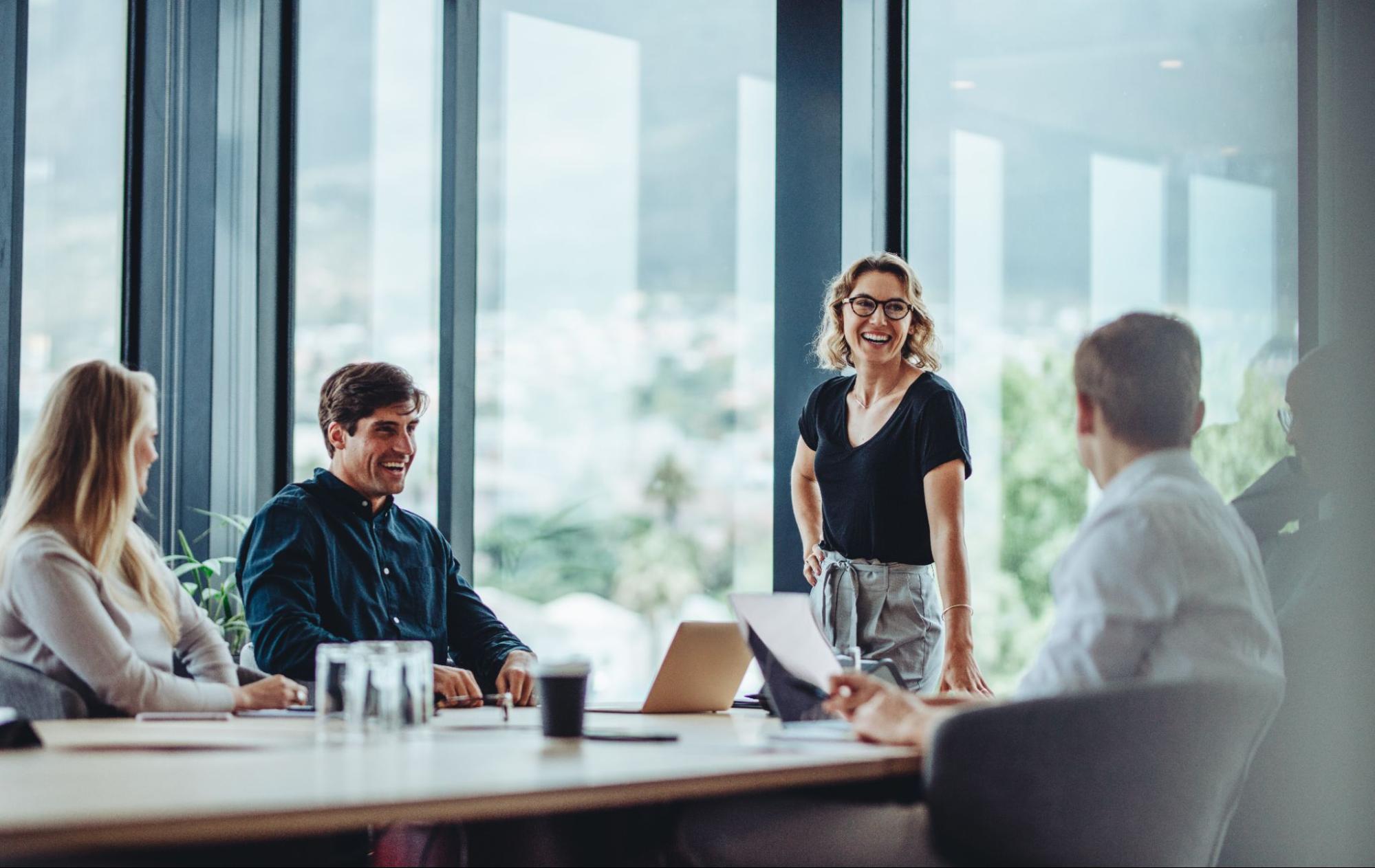 Four office workers gather around a conference table